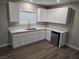 Modern kitchen with white cabinetry, countertops, and stainless steel appliances at 1345 N Hollywood Blvd, Las Vegas, NV 89110