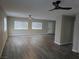 Large, empty living room with wood floors and large windows at 1345 N Hollywood Blvd, Las Vegas, NV 89110