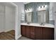 Bathroom features dual sinks with modern fixtures, framed mirrors and decorative tile backsplash at 1525 Spiced Wine Ave # 12103, Henderson, NV 89074