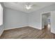 Open, bright bedroom with wood floors and connecting doorway to an adjacent room at 1525 Spiced Wine Ave # 12103, Henderson, NV 89074