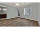 Large bedroom featuring wood flooring, a ceiling fan, and views to bathroom and doorway at 1525 Spiced Wine Ave # 12103, Henderson, NV 89074