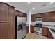 Kitchen with wooden cabinets, stainless steel appliances, and granite countertops at 1525 Spiced Wine Ave # 12103, Henderson, NV 89074