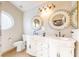 Charming bathroom featuring a double vanity with decorative mirrors and a round window for natural light at 155 Fallon Dr, Henderson, NV 89074