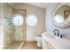 Modern bathroom featuring a walk-in shower with stone walls, a round window, and a decorative vanity at 155 Fallon Dr, Henderson, NV 89074