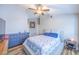 Bright bedroom featuring a ceiling fan, light grey paint, wood-look floors, and a matching dresser and nightstand at 155 Fallon Dr, Henderson, NV 89074