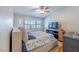 Spacious bedroom features a bay window with shutters, a ceiling fan, and a mounted television on a wood shelf at 155 Fallon Dr, Henderson, NV 89074