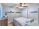 Cozy bedroom with a ceiling fan, a patterned comforter, and built-in shelving above a wooden dresser at 155 Fallon Dr, Henderson, NV 89074