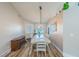 Bright dining room with modern chandelier, large table and chairs, and window at 155 Fallon Dr, Henderson, NV 89074