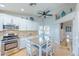Open kitchen features stainless steel appliances, a large dining table, and tile flooring for modern appeal at 155 Fallon Dr, Henderson, NV 89074