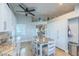 Bright kitchen features granite counters, white cabinets and a charming eat-in area with a farmhouse table at 155 Fallon Dr, Henderson, NV 89074