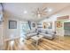 Bright living room featuring wood-look flooring, comfortable seating, and sliding door access to the backyard at 155 Fallon Dr, Henderson, NV 89074