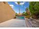 Relaxing backyard pool area with patio, landscaping, and a tall palm tree at 155 Fallon Dr, Henderson, NV 89074