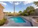 Inviting pool in a private backyard with shade coverings and desert landscaping at 155 Fallon Dr, Henderson, NV 89074