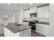 Modern kitchen with stainless steel appliances, gray countertops, and white cabinets at 1704 Desert Path Ave, North Las Vegas, NV 89032