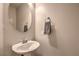 Bright bathroom features a modern round mirror and convenient towel rack at 173 Petaluma Valley Dr, Las Vegas, NV 89138