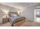 Cozy bedroom with a wooden bed frame, stylish lamps, and inviting decor at 173 Petaluma Valley Dr, Las Vegas, NV 89138
