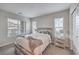 Well-lit bedroom with a queen bed, modern decor, and natural light at 173 Petaluma Valley Dr, Las Vegas, NV 89138