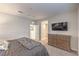 Bright bedroom features a TV mounted over a dresser and neutral decor at 173 Petaluma Valley Dr, Las Vegas, NV 89138