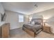 Calm bedroom with a wooden headboard, soft lighting, and neutral decor at 173 Petaluma Valley Dr, Las Vegas, NV 89138