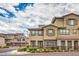 Beautiful exterior view of a tan two-story townhouse with a red tile roof and decorative shutters at 173 Petaluma Valley Dr, Las Vegas, NV 89138
