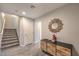 Inviting foyer featuring wood-look floors, decorative mirror, and staircase leading to the second floor at 173 Petaluma Valley Dr, Las Vegas, NV 89138