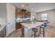 Modern kitchen island with stainless steel sink, breakfast bar, and dark wood cabinets at 173 Petaluma Valley Dr, Las Vegas, NV 89138