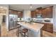 Well-lit kitchen with stainless steel appliances, central island, and dark cabinets at 173 Petaluma Valley Dr, Las Vegas, NV 89138