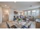 Open-concept living room featuring a modern glass table and comfortable couches at 173 Petaluma Valley Dr, Las Vegas, NV 89138
