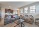 Comfortable living room with plush couches, natural light, and an open kitchen at 173 Petaluma Valley Dr, Las Vegas, NV 89138