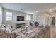 Comfortable living room with wood-look floors, a large couch, a TV, and a dining table at 173 Petaluma Valley Dr, Las Vegas, NV 89138