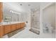 Bright bathroom featuring marble floors, double sinks, and a separate shower stall with glass doors at 1912 Summer Pine Ct # 102, Las Vegas, NV 89134