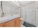 Bright bathroom with tile countertops, a glass-enclosed shower and bath, and neutral decor at 1912 Summer Pine Ct # 102, Las Vegas, NV 89134
