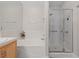 Bright bathroom featuring a tub, a separate shower stall with glass doors, and white tile at 1912 Summer Pine Ct # 102, Las Vegas, NV 89134