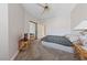 Simple carpeted bedroom, complete with ceiling fan, sliding closet, and a small flatscreen TV at 1912 Summer Pine Ct # 102, Las Vegas, NV 89134