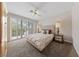 Comfortable bedroom features a tufted headboard, neutral tones, and lots of natural light from the window at 1912 Summer Pine Ct # 102, Las Vegas, NV 89134