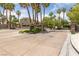 Gated community entrance with lush landscaping and palm trees for a secure and welcoming atmosphere at 1912 Summer Pine Ct # 102, Las Vegas, NV 89134