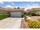Inviting single-story home with a two-car garage and colorful, desert-friendly landscaping at 1912 Summer Pine Ct # 102, Las Vegas, NV 89134