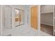 Bright hallway with white marble floors, cabinet storage, and entrances to the closet and bathroom at 1912 Summer Pine Ct # 102, Las Vegas, NV 89134