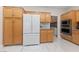 Modern kitchen with stainless steel appliances, ample maple cabinetry, and marble countertops at 1912 Summer Pine Ct # 102, Las Vegas, NV 89134