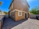 Exterior shot of a house backyard with a gravel landscape and perimeter fence at 1995 Sundown Canyon Dr, Henderson, NV 89014