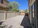 Narrow backyard showcasing a gravel landscape and a perimeter fence for privacy at 1995 Sundown Canyon Dr, Henderson, NV 89014