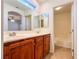 Bathroom featuring double sinks, a spacious vanity, and a separate tub and toilet area at 1995 Sundown Canyon Dr, Henderson, NV 89014