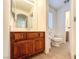 Bathroom with a wooden vanity, toilet, and tile floors; perfect for a quick refresh at 1995 Sundown Canyon Dr, Henderson, NV 89014
