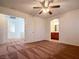 A spacious bedroom with ceiling fan and adjacent bathroom entry adds convenience and functionality at 1995 Sundown Canyon Dr, Henderson, NV 89014