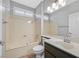 Bathroom featuring a jacuzzi tub, dark cabinets and a single sink with a mirrored wall at 2328 Fossil Canyon Dr, Henderson, NV 89052