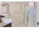Cozy bathroom featuring a shower with glass door and a vanity with mirror at 2328 Fossil Canyon Dr, Henderson, NV 89052