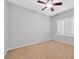 Bedroom with neutral carpet, ceiling fan, and plantation shutters offering natural light at 2328 Fossil Canyon Dr, Henderson, NV 89052