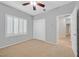Bedroom featuring neutral carpet, ceiling fan, and plantation shutters offering ample lighting at 2328 Fossil Canyon Dr, Henderson, NV 89052
