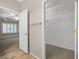 Hallway with a walk-in closet featuring wire shelving, next to a bedroom with plantation shutters at 2328 Fossil Canyon Dr, Henderson, NV 89052