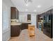 Well-appointed kitchen with dark cabinets, stainless steel appliances, and tile backsplash at 2328 Fossil Canyon Dr, Henderson, NV 89052